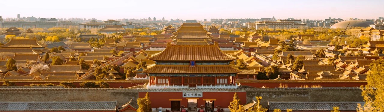 The red walls and intricate roof of Forbidden City after snow, Beijing, China.